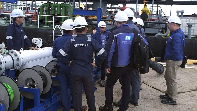 Metcore and Endress+Hauser gathered around a master meter proving skid